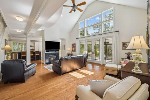 a living room with furniture ceiling fan and a rug
