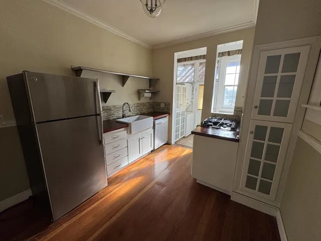 a kitchen with sink refrigerator and window
