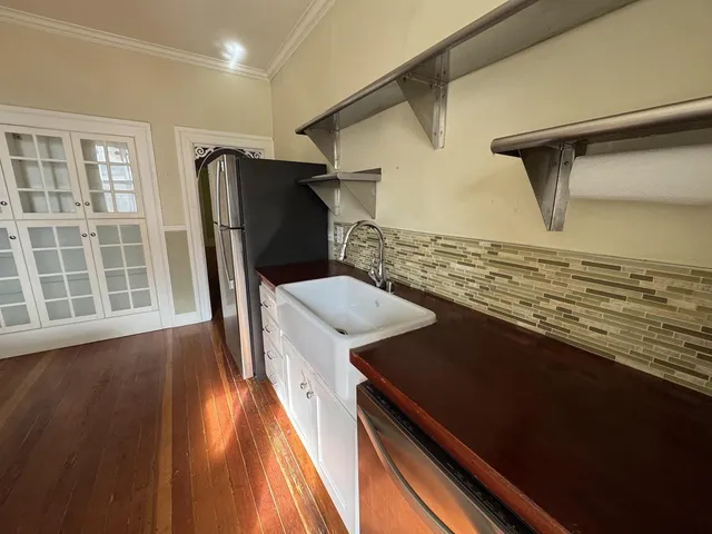 a kitchen with a refrigerator and a stove