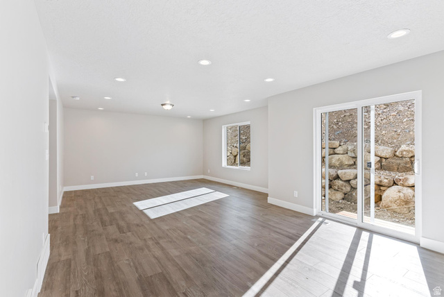 387 Slant Road, Unit 30 Spanish Fork, UT 84660 - Photo 9 of 25 Spacious room featuring wood-finish flooring, recessed lighting, and light-toned walls