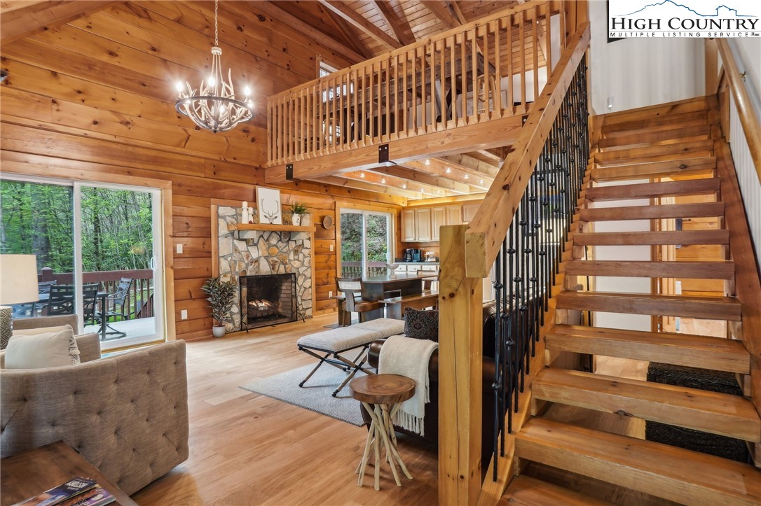 a view of hall way with furniture and a chandelier