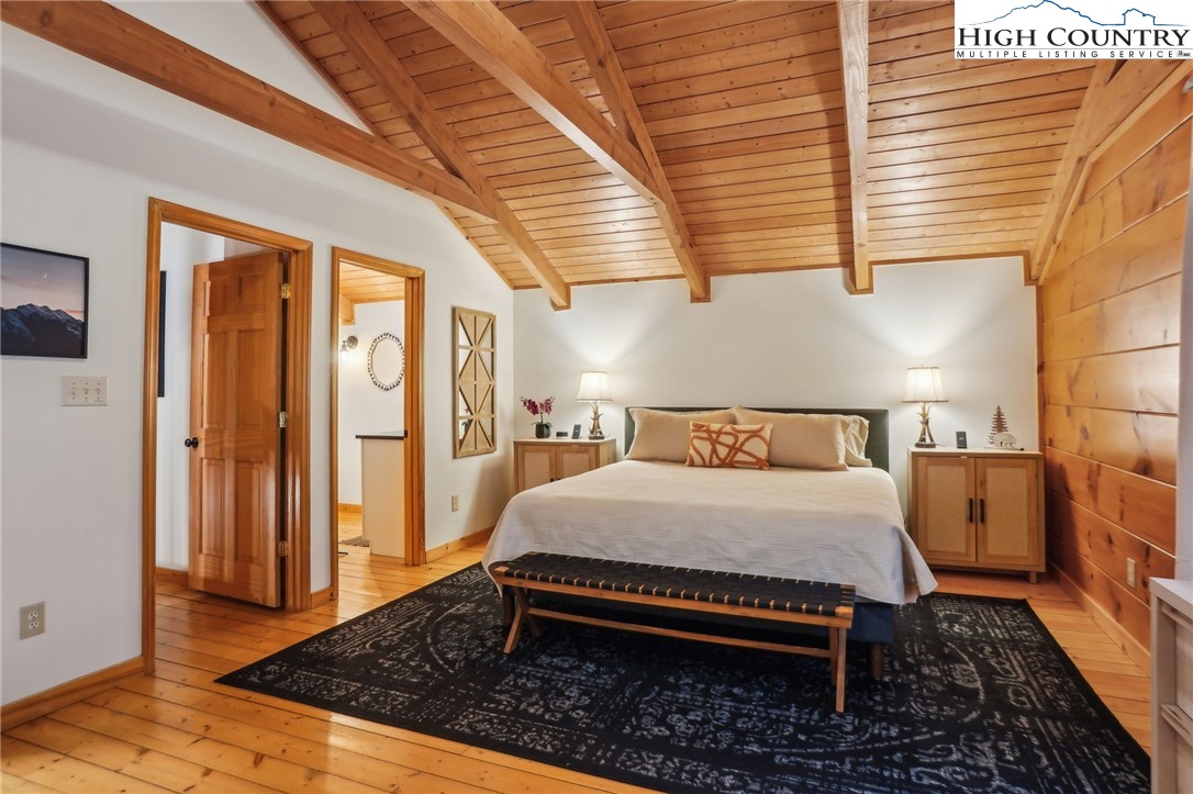 909 Niley Cook Road Blowing Rock, NC 28605 - Photo 14 of 45 a bedroom with a bed and wooden floor