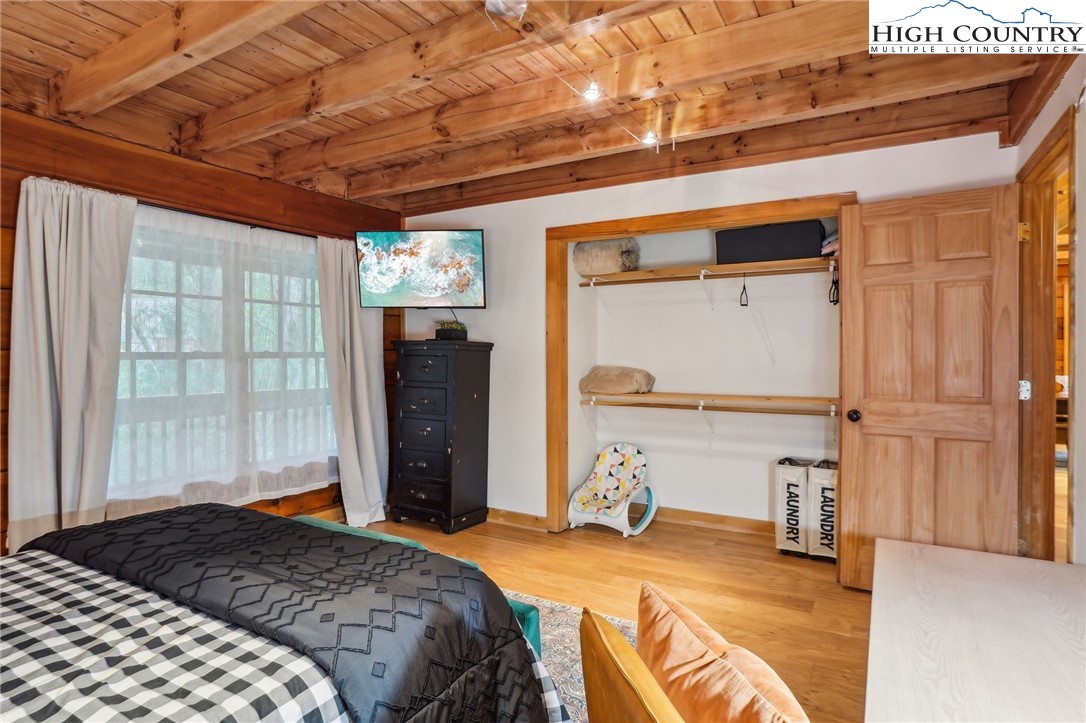 909 Niley Cook Road Blowing Rock, NC 28605 - Photo 18 of 45 a bedroom with a bed and a window