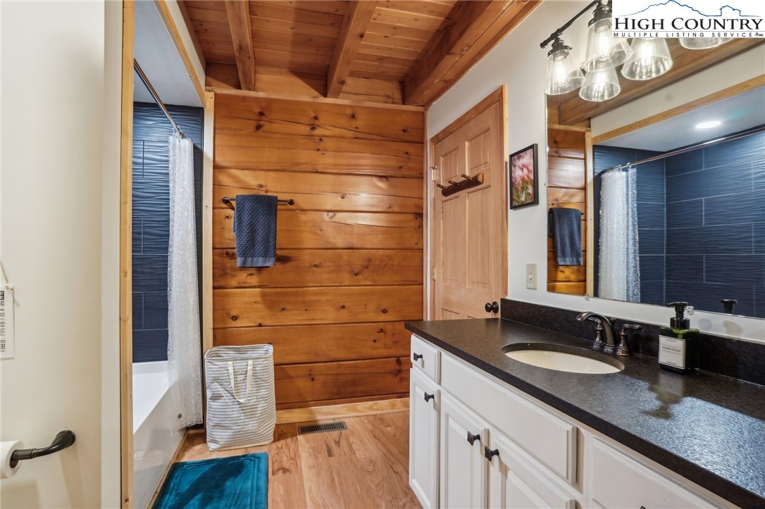 909 Niley Cook Road Blowing Rock, NC 28605 - Photo 19 of 45 a bathroom with a granite countertop sink a mirror and shower