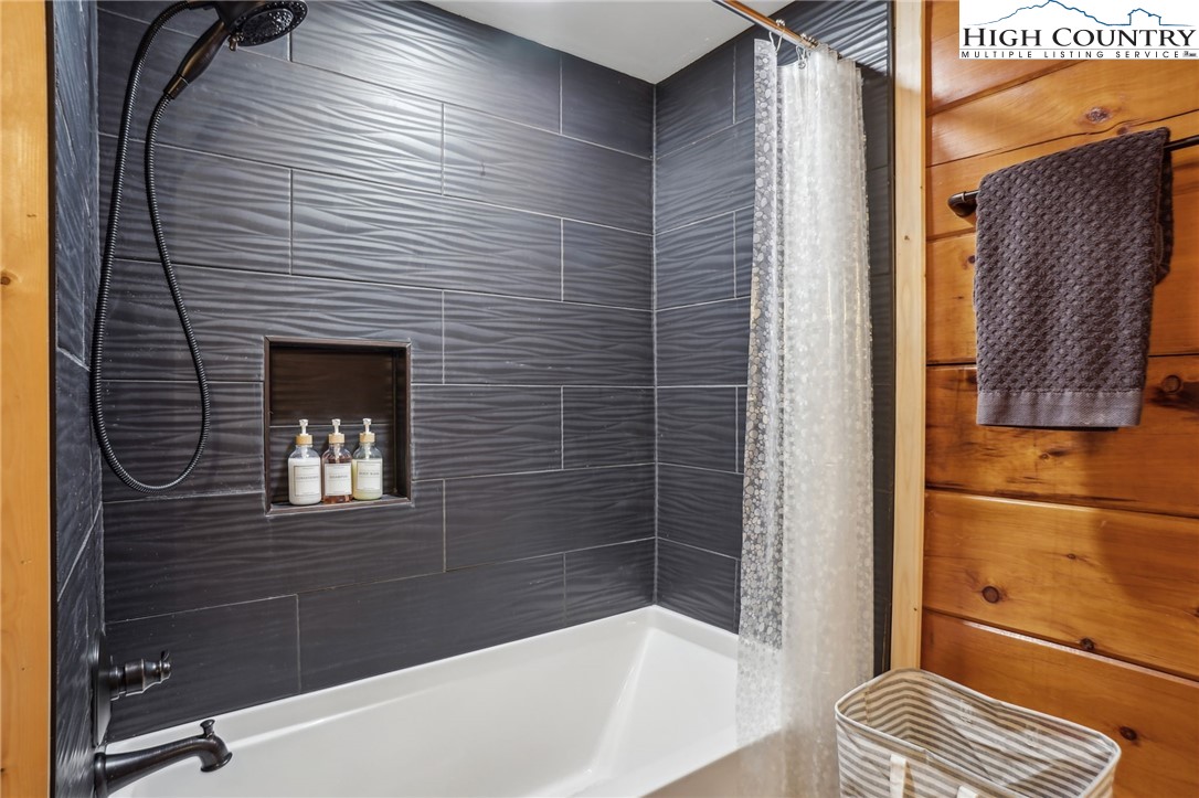 909 Niley Cook Road Blowing Rock, NC 28605 - Photo 20 of 45 a bathroom with a bathtub and shower