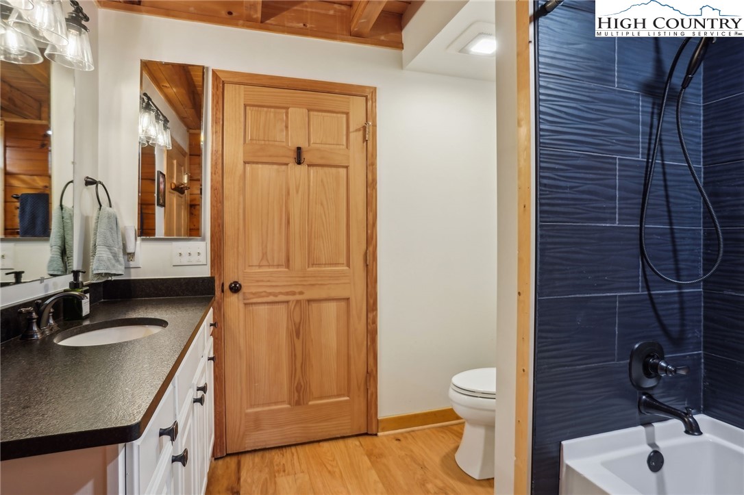 909 Niley Cook Road Blowing Rock, NC 28605 - Photo 21 of 45 a bathroom with a granite countertop sink toilet and shower