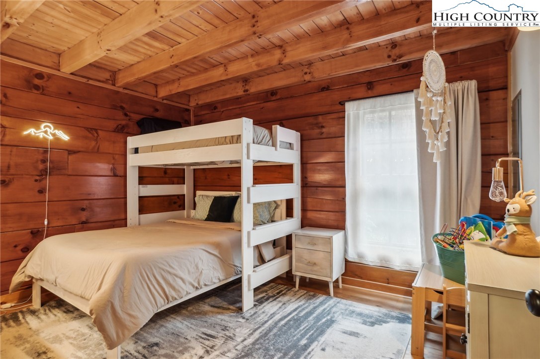 909 Niley Cook Road Blowing Rock, NC 28605 - Photo 22 of 45 a bed room with a bed and a chair