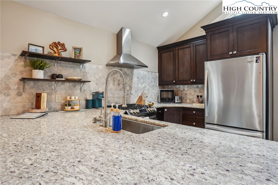 909 Niley Cook Road Blowing Rock, NC 28605 - Photo 30 of 45 a kitchen with stainless steel appliances granite countertop a refrigerator sink and stove
