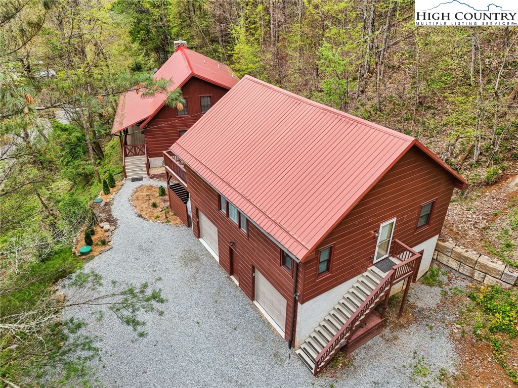 909 Niley Cook Road Blowing Rock, NC 28605 - Photo 3 of 45 a backyard of a house with wooden floor and large trees