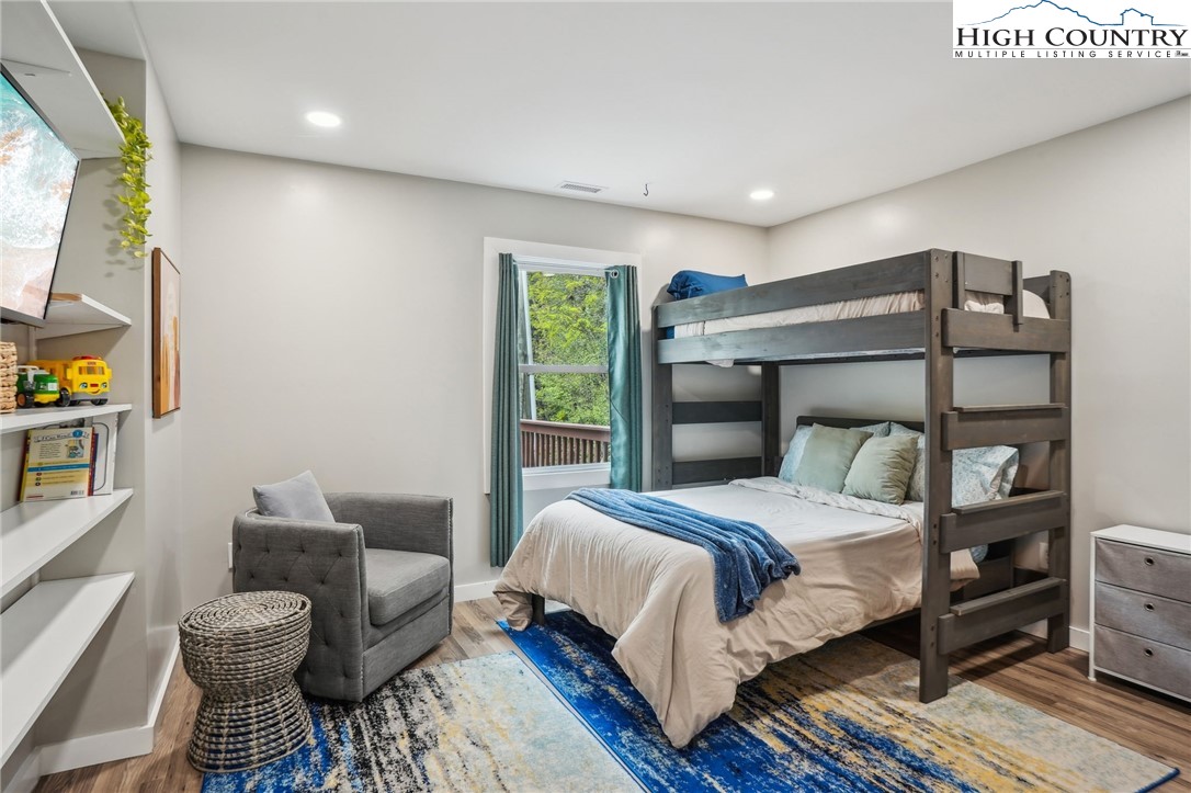 909 Niley Cook Road Blowing Rock, NC 28605 - Photo 33 of 45 a bedroom with a bed and wooden floor