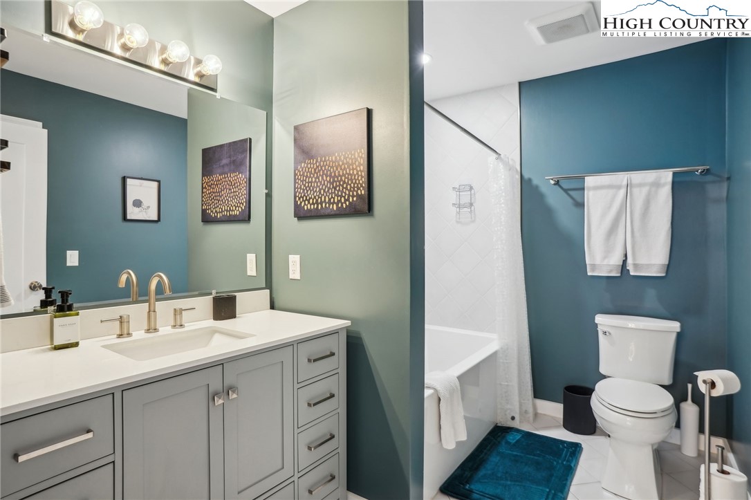 909 Niley Cook Road Blowing Rock, NC 28605 - Photo 34 of 45 a bathroom with a sink a toilet a shower and a mirror