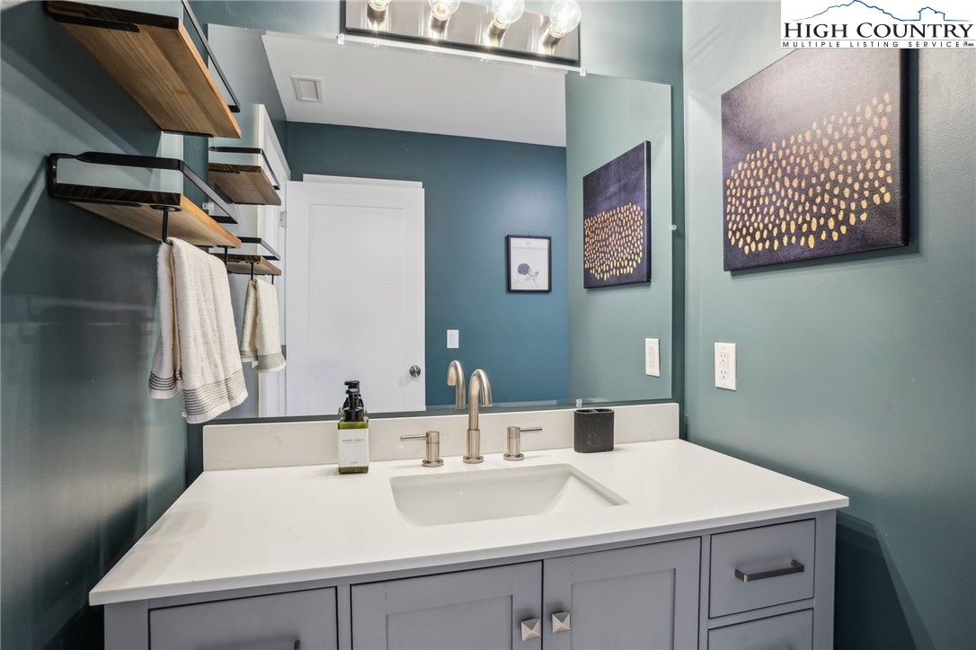 909 Niley Cook Road Blowing Rock, NC 28605 - Photo 35 of 45 a bathroom with a sink and a mirror