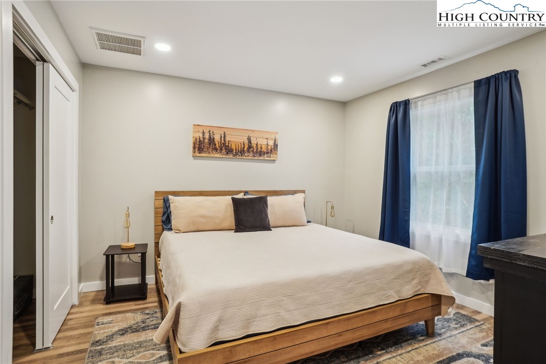 909 Niley Cook Road Blowing Rock, NC 28605 - Photo 36 of 45 a bedroom with a large bed and a large mirror