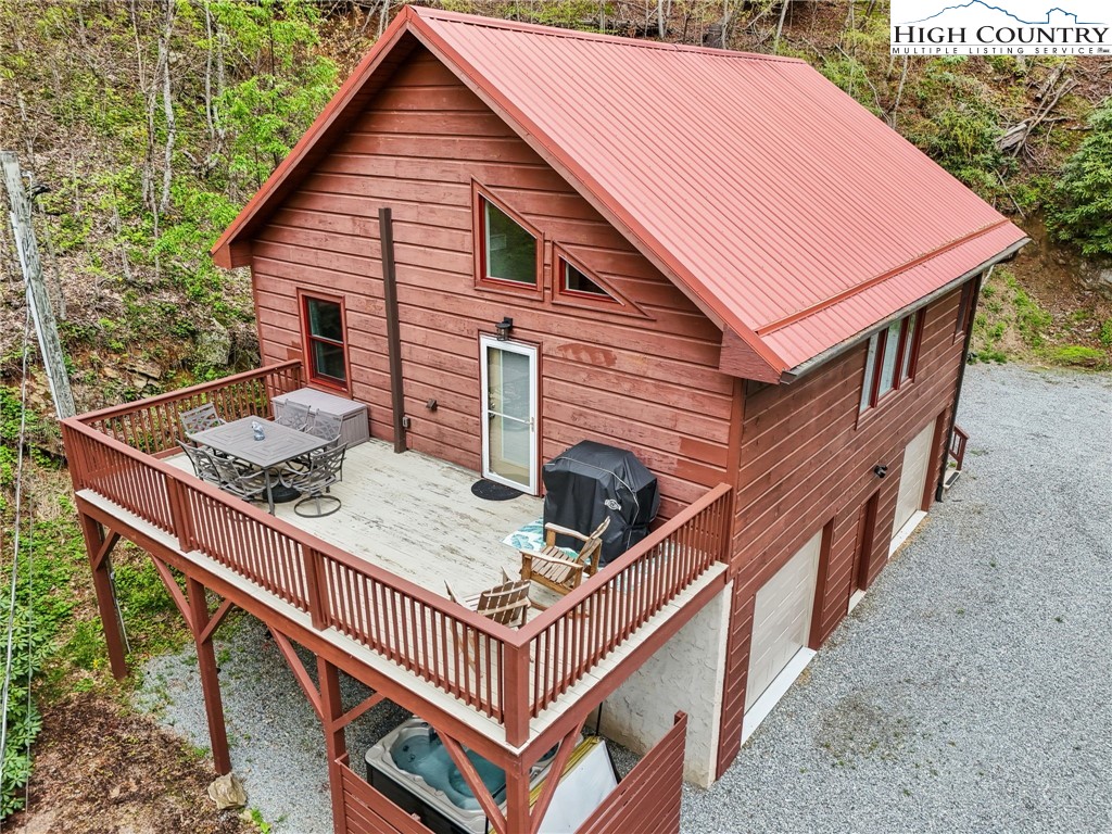 909 Niley Cook Road Blowing Rock, NC 28605 - Photo 40 of 45 a view of a house with wooden deck and furniture