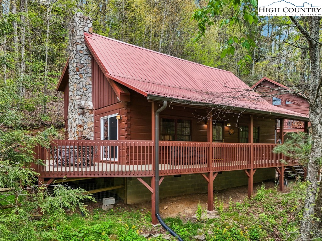 909 Niley Cook Road Blowing Rock, NC 28605 - Photo 4 of 45 a view of a chair and table in the backyard