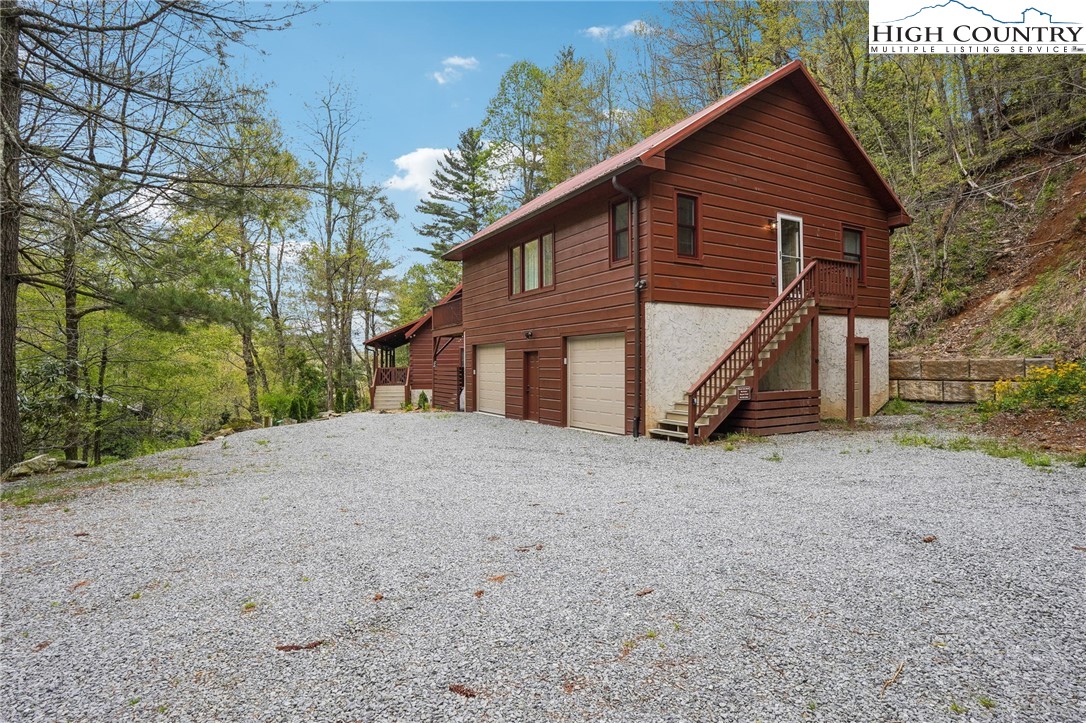 909 Niley Cook Road Blowing Rock, NC 28605 - Photo 43 of 45 a view of a house with a yard and large tree