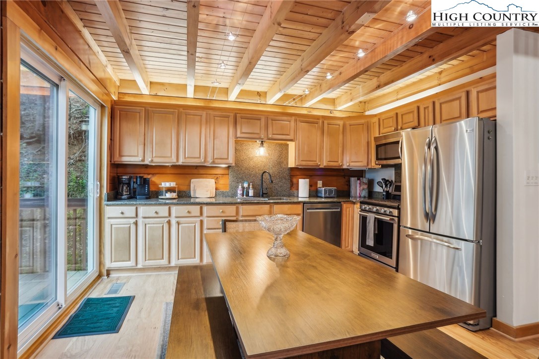 909 Niley Cook Road Blowing Rock, NC 28605 - Photo 9 of 45 a kitchen with stainless steel appliances a refrigerator and a stove