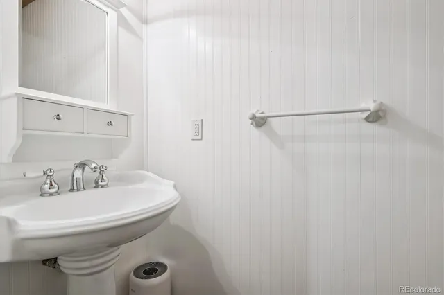 a bathroom with a sink a toilet and mirror