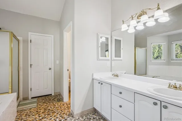 a bathroom with a sink a light fixture and a mirror