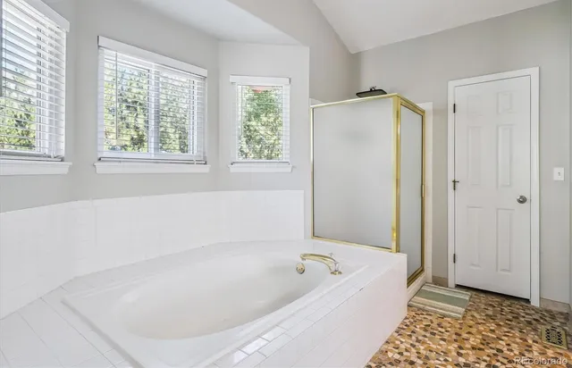 a bathroom with a bathtub and a shower