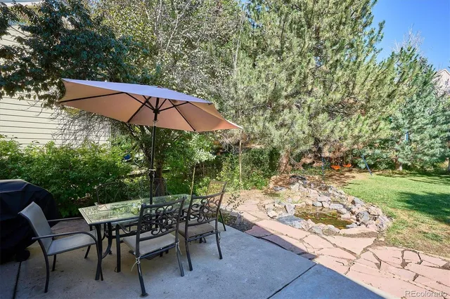 an outdoor space with furniture and umbrella