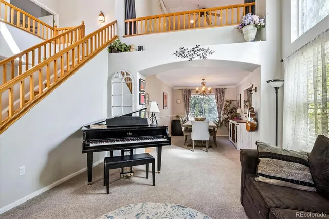 a living room with furniture and a piano