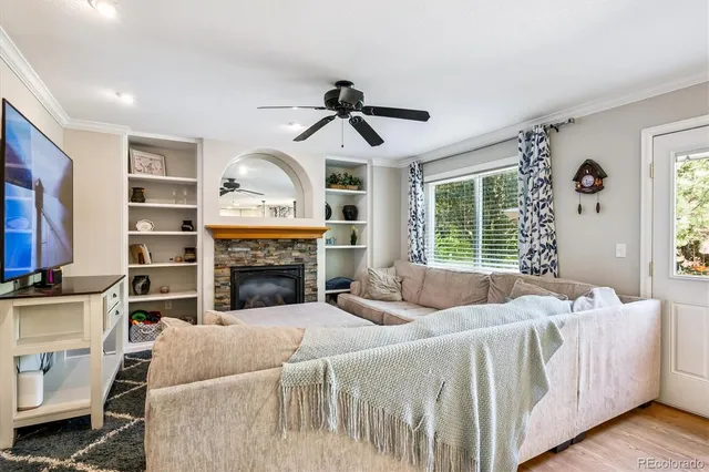 a living room with furniture a fireplace and a flat screen tv
