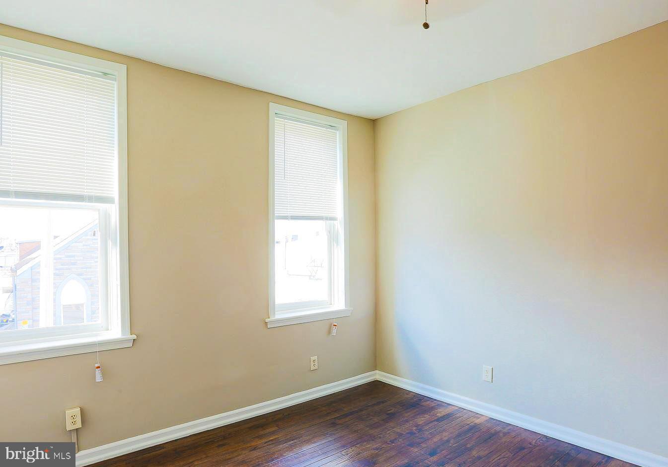 1114 West Cross Street Baltimore, MD 21230 - Photo 13 of 19 a view of an empty room with wooden floor and a window