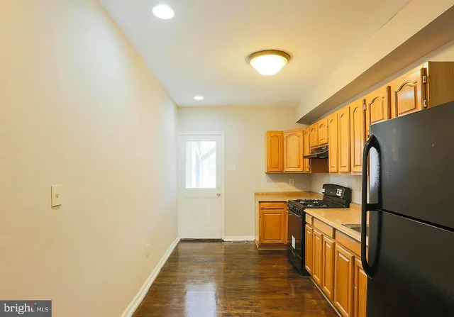 a kitchen with stainless steel appliances a refrigerator sink and stove