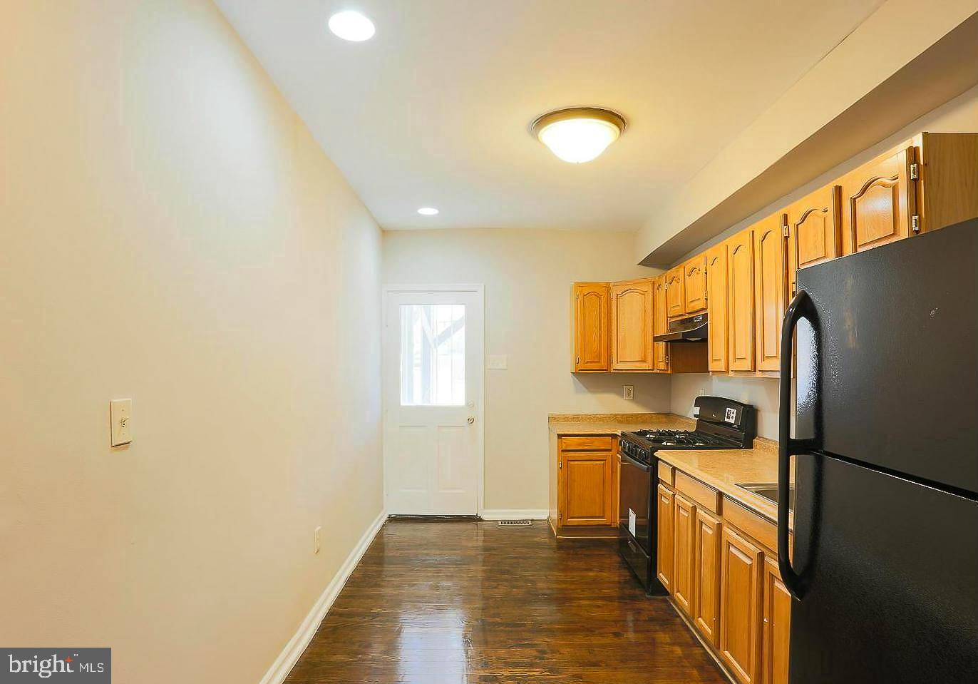 1114 West Cross Street Baltimore, MD 21230 - Photo 6 of 19 a kitchen with stainless steel appliances a refrigerator sink and stove