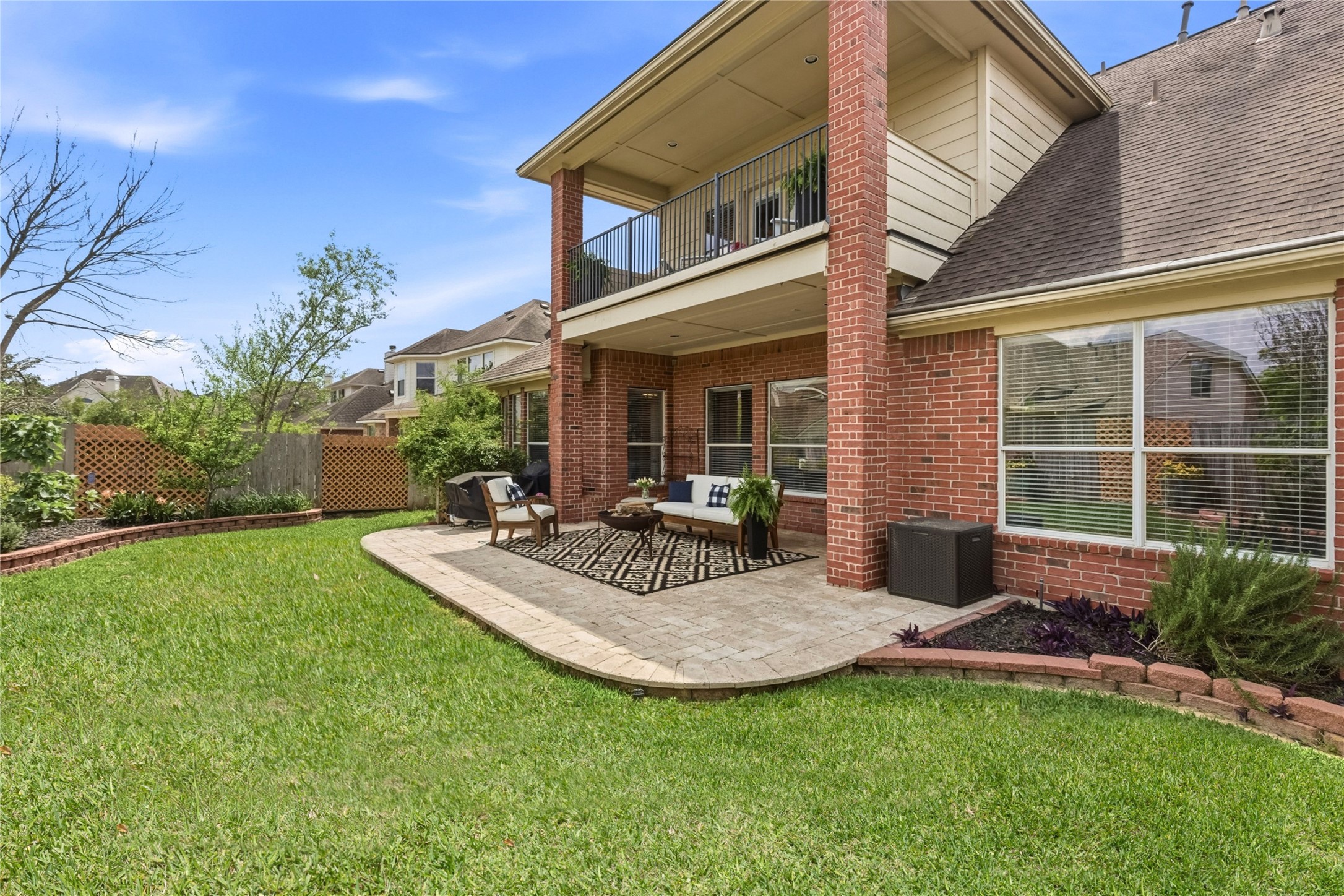 20722 Windrose Bend Drive Spring, TX 77379 - Photo 6 of 50 Serene living offered here with lush landscaping featuring majestic oak trees, fragrant night-blooming jasmine, and a vibrant array of plants like crepe myrtles, fig and plum trees, and colorful blooms including canna lilies and gold lantana, creating a breathtaking oasis in your own backyard.