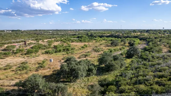 a view of a patio with lawn chairs floor to ceiling window and outdoor view