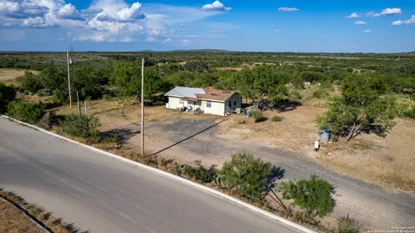 a view of a backyard and swimming pool