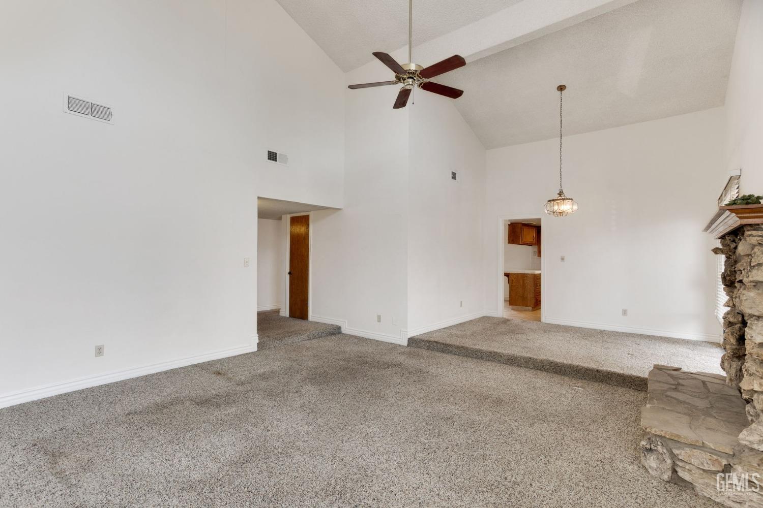 Undisclosed Address Bakersfield, CA 93306 - Photo 15 of 51 a view of a livingroom with a ceiling fan & a window