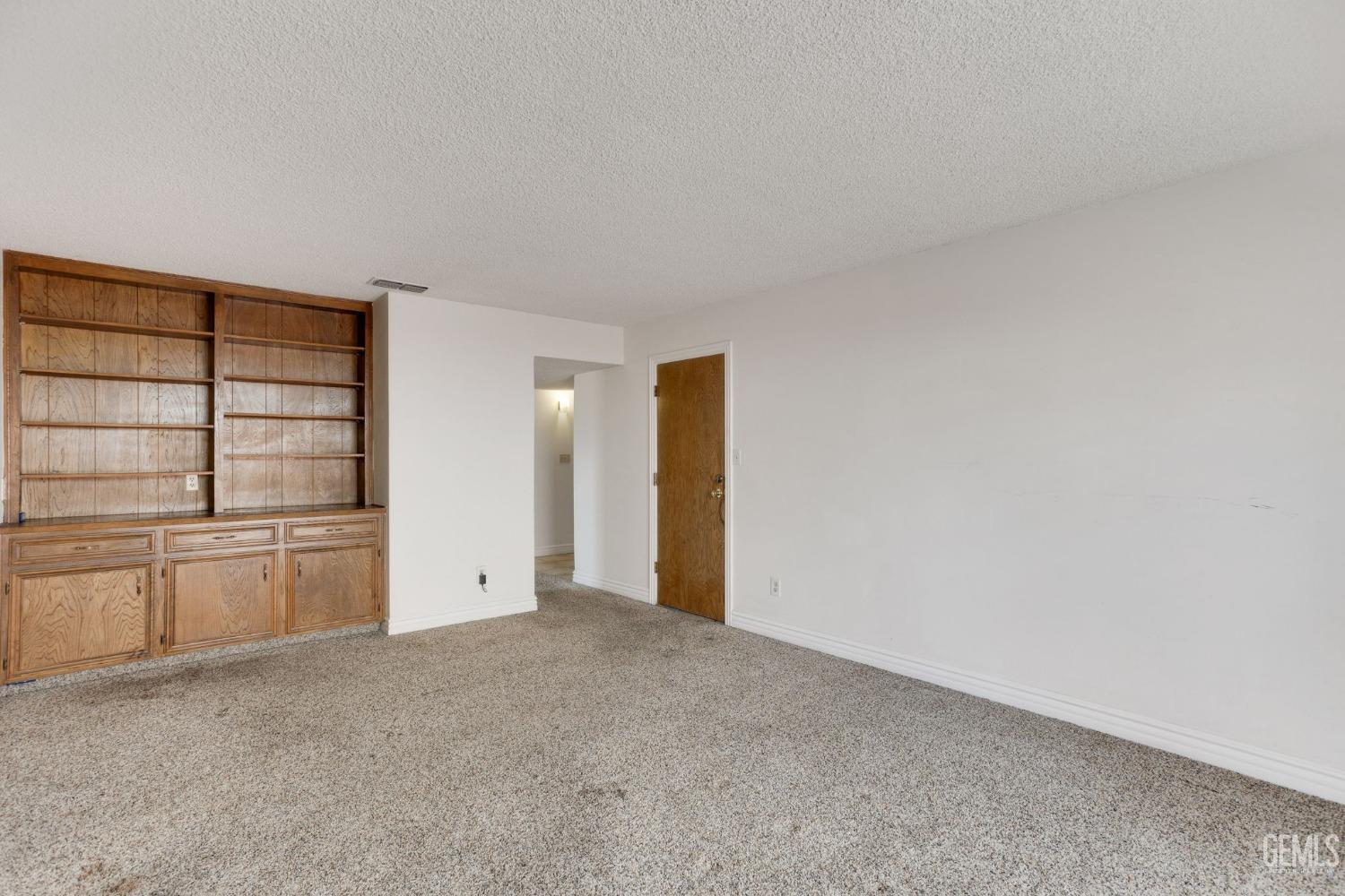 Undisclosed Address Bakersfield, CA 93306 - Photo 20 of 51 a view of an empty room with window and cabinet