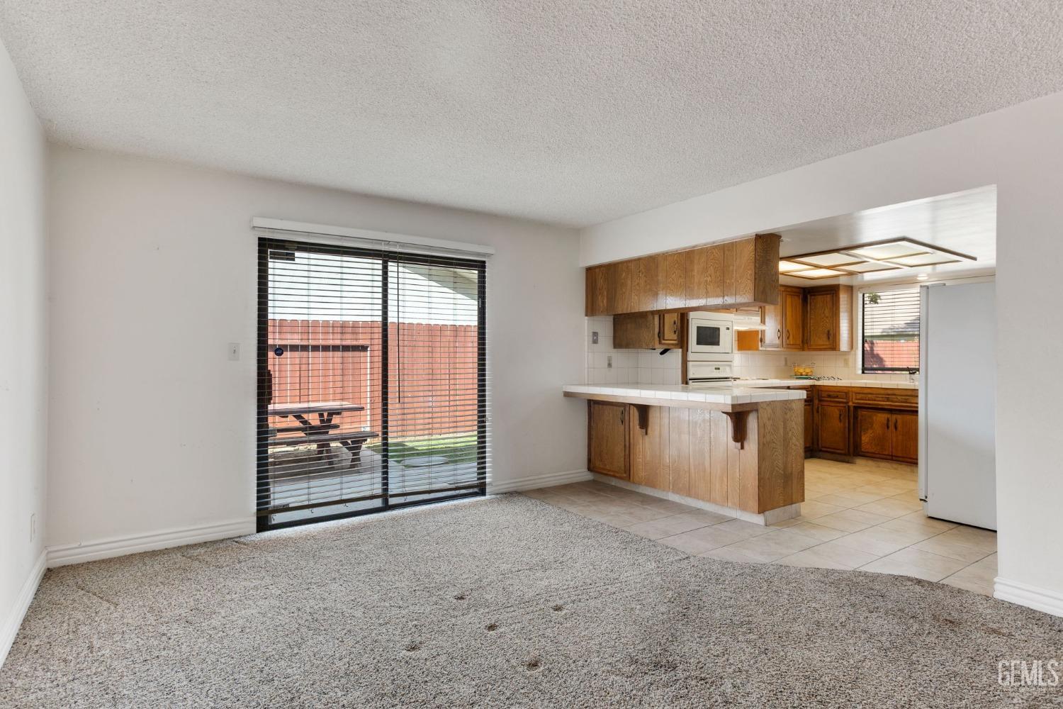 Undisclosed Address Bakersfield, CA 93306 - Photo 21 of 51 a living room with stainless steel appliances kitchen island granite countertop a sink and cabinets