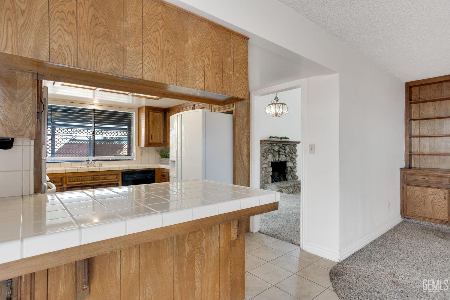 Undisclosed Address Bakersfield, CA 93306 - Photo 23 of 51 a kitchen with stainless steel appliances kitchen island granite countertop a refrigerator and a stove
