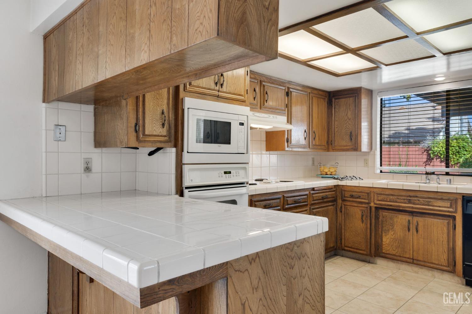 Undisclosed Address Bakersfield, CA 93306 - Photo 24 of 51 a kitchen that has a sink and a stove in it