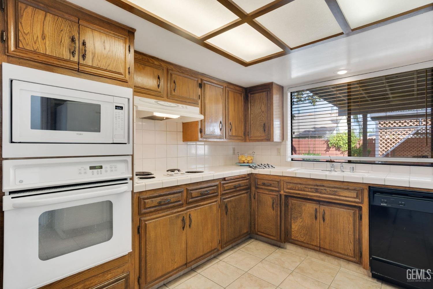 Undisclosed Address Bakersfield, CA 93306 - Photo 25 of 51 a kitchen with stainless steel appliances granite countertop a stove sink and cabinets