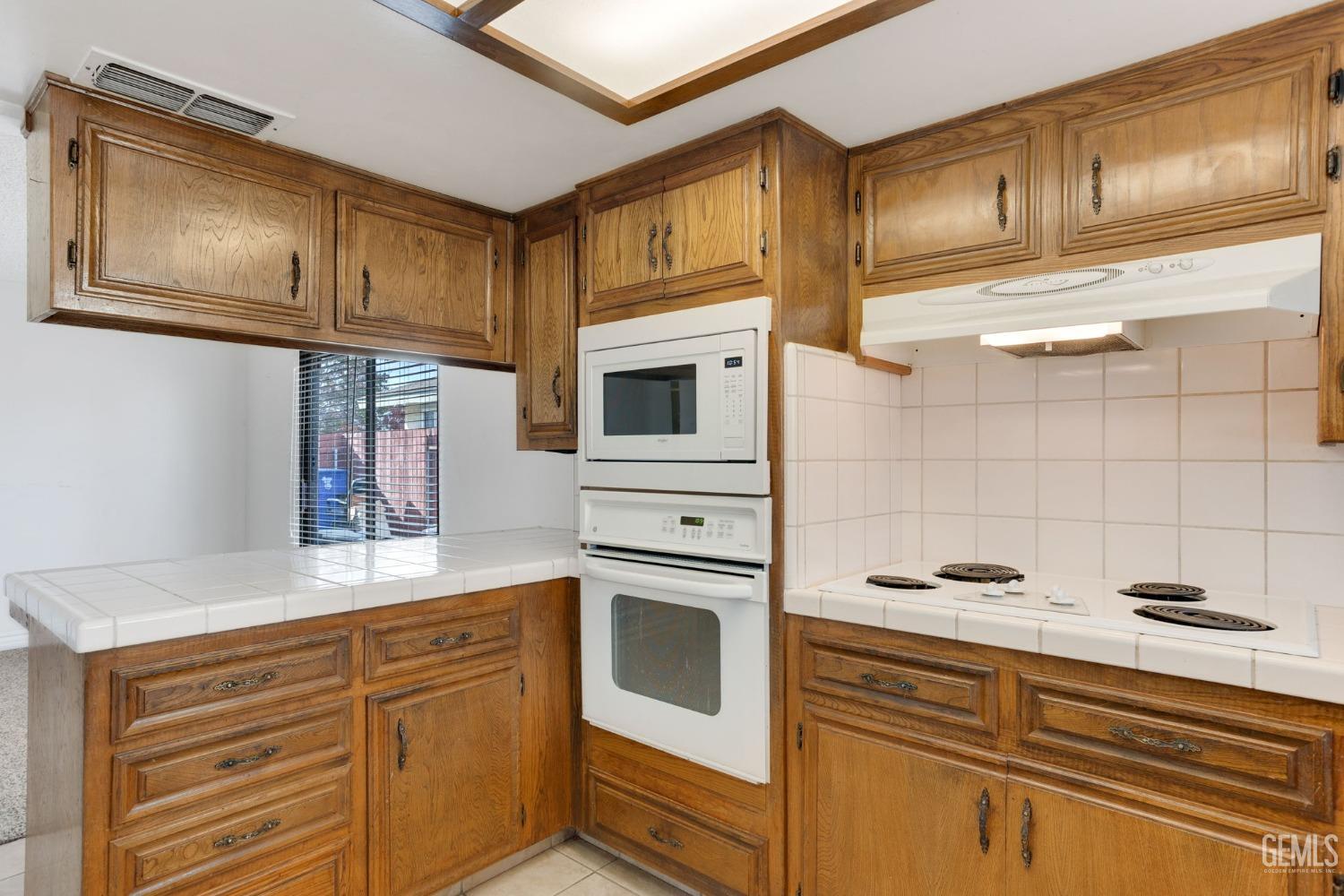 Undisclosed Address Bakersfield, CA 93306 - Photo 29 of 51 a kitchen with stainless steel appliances granite countertop a sink a stove and cabinets