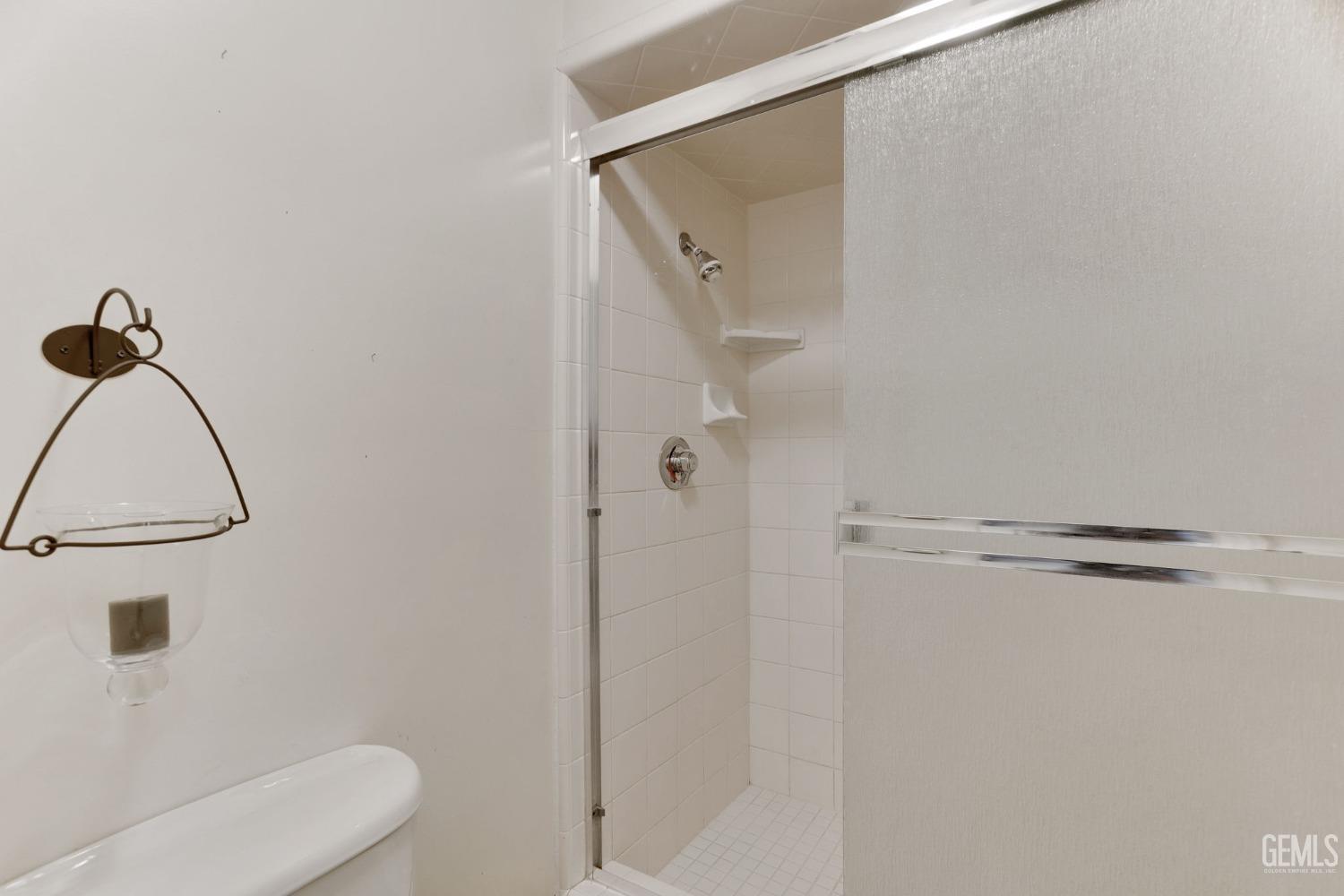 Undisclosed Address Bakersfield, CA 93306 - Photo 37 of 51 a bathroom with a shower and a toilet