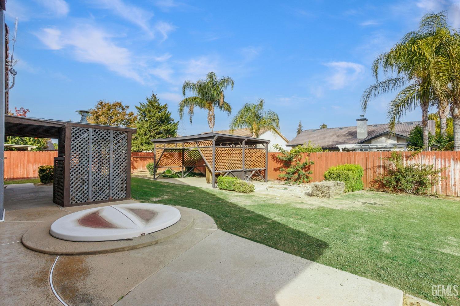 Undisclosed Address Bakersfield, CA 93306 - Photo 45 of 51 a backyard of a house with table and chairs plants