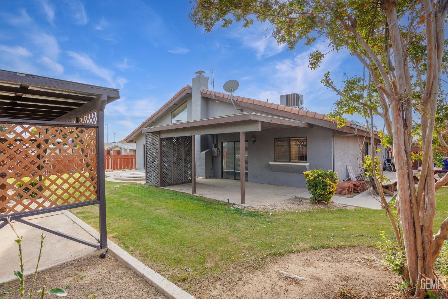 Undisclosed Address Bakersfield, CA 93306 - Photo 47 of 51 a front view of a house with garden