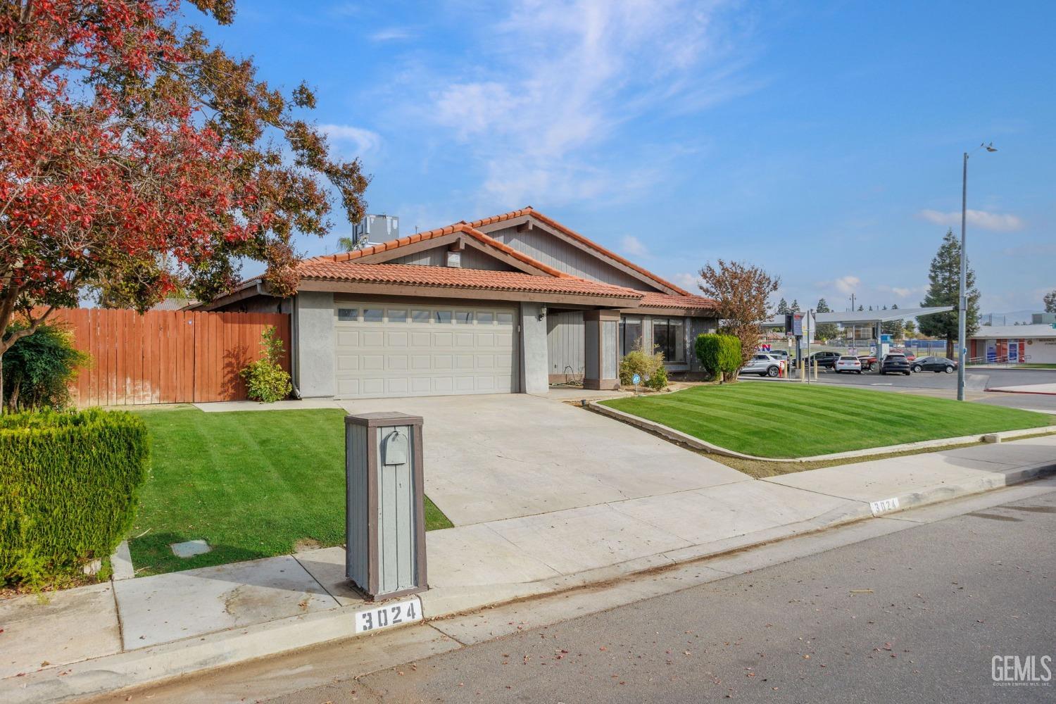 Undisclosed Address Bakersfield, CA 93306 - Photo 5 of 51 a front view of a house with a yard