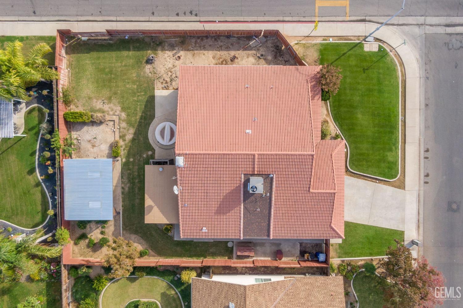 Undisclosed Address Bakersfield, CA 93306 - Photo 51 of 51 a front view of a house with a garden and plants