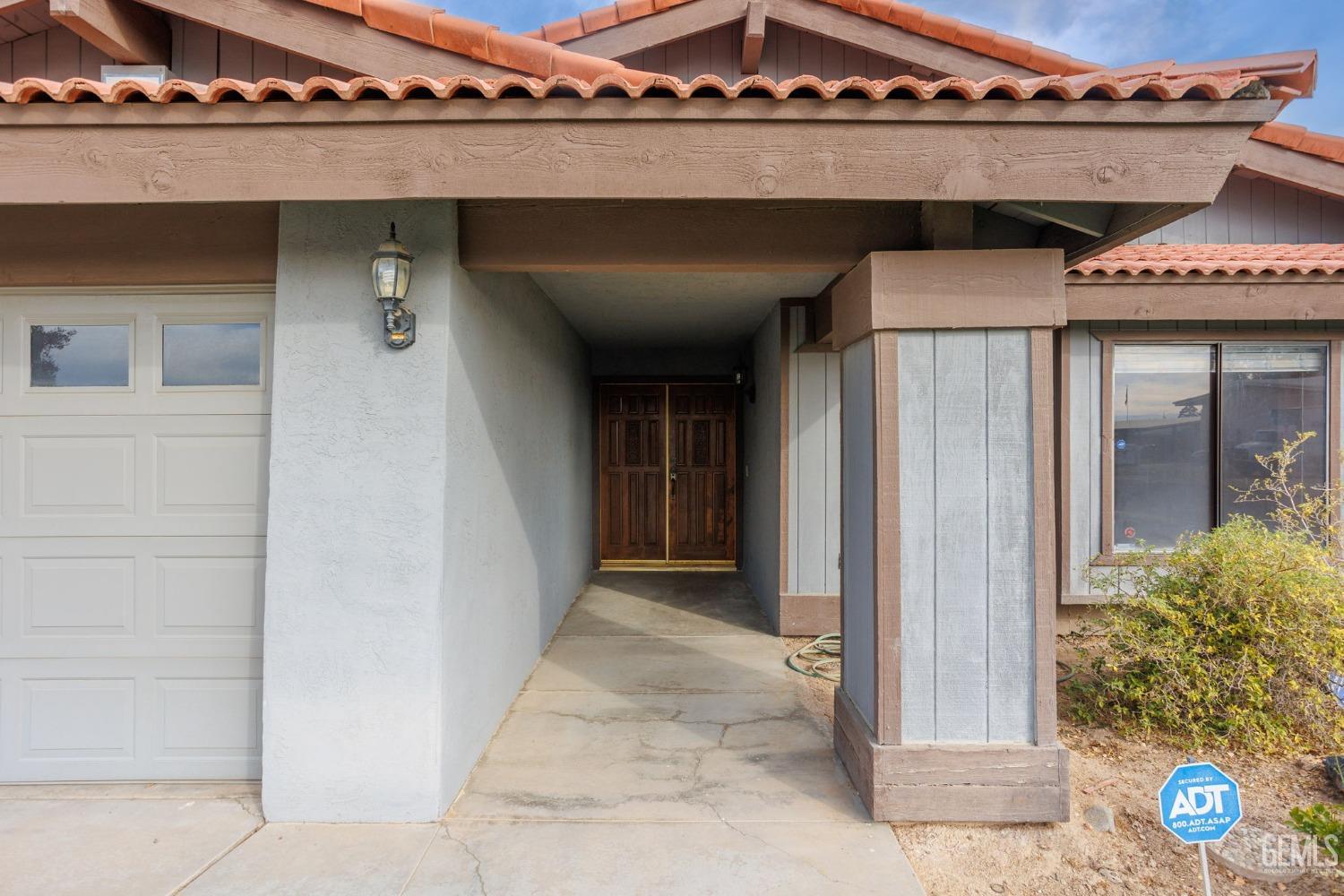 Undisclosed Address Bakersfield, CA 93306 - Photo 8 of 51 a front view of a house with parking space