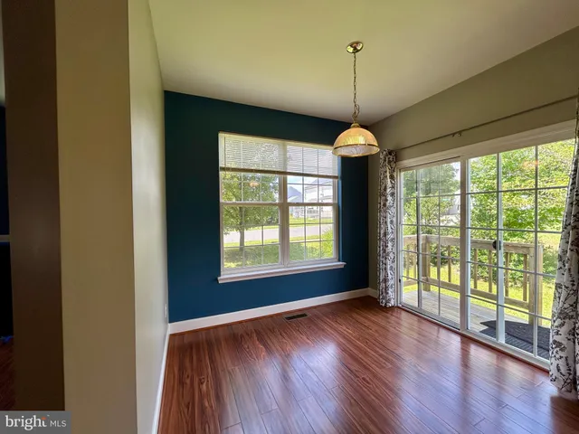 a room with wooden floor and furniture
