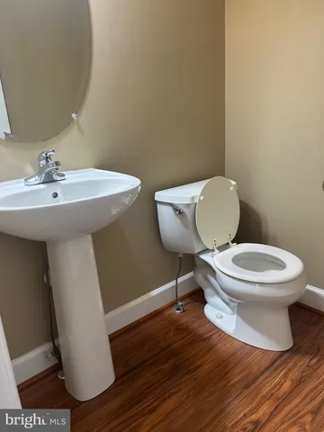 a white toilet sitting next to a bathroom sink