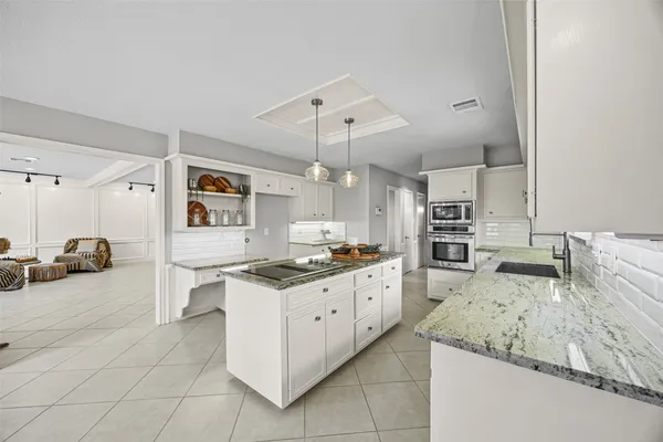 a kitchen with a sink stove and cabinets
