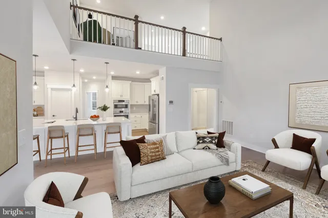 a living room with furniture and a view of kitchen